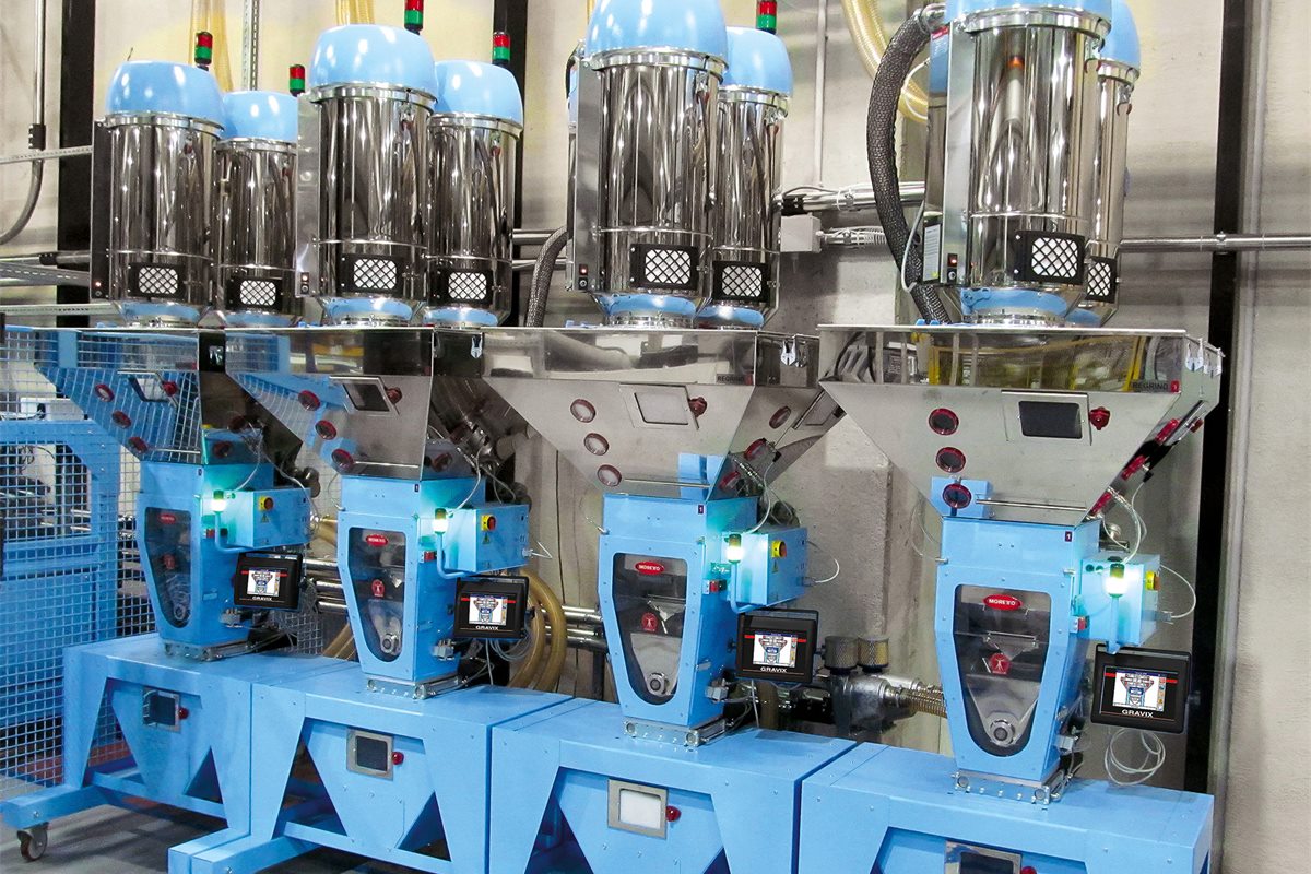 Bank of Moretto GRAVIX dosing units with hopper loaders feeding processing machines