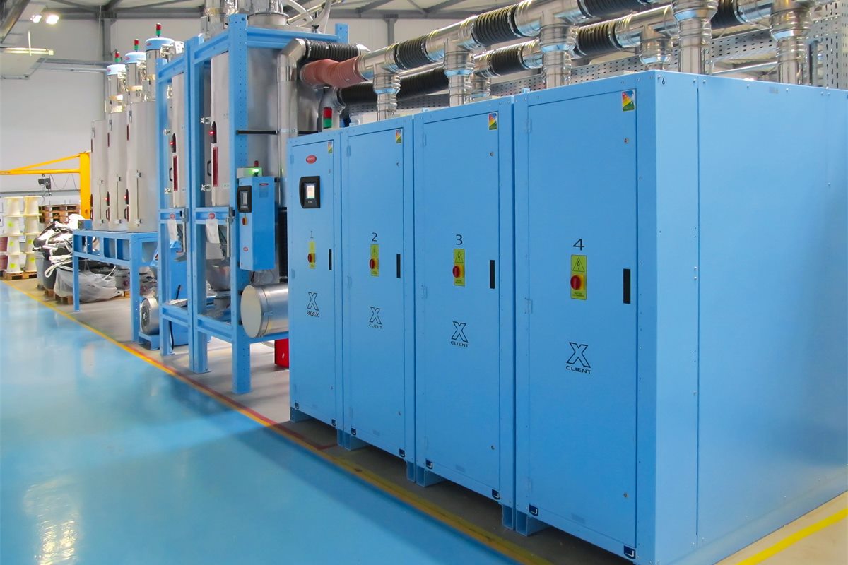 Moretto drying plant with dryers, insulated hoppers and hopper loaders installed on a factory floor